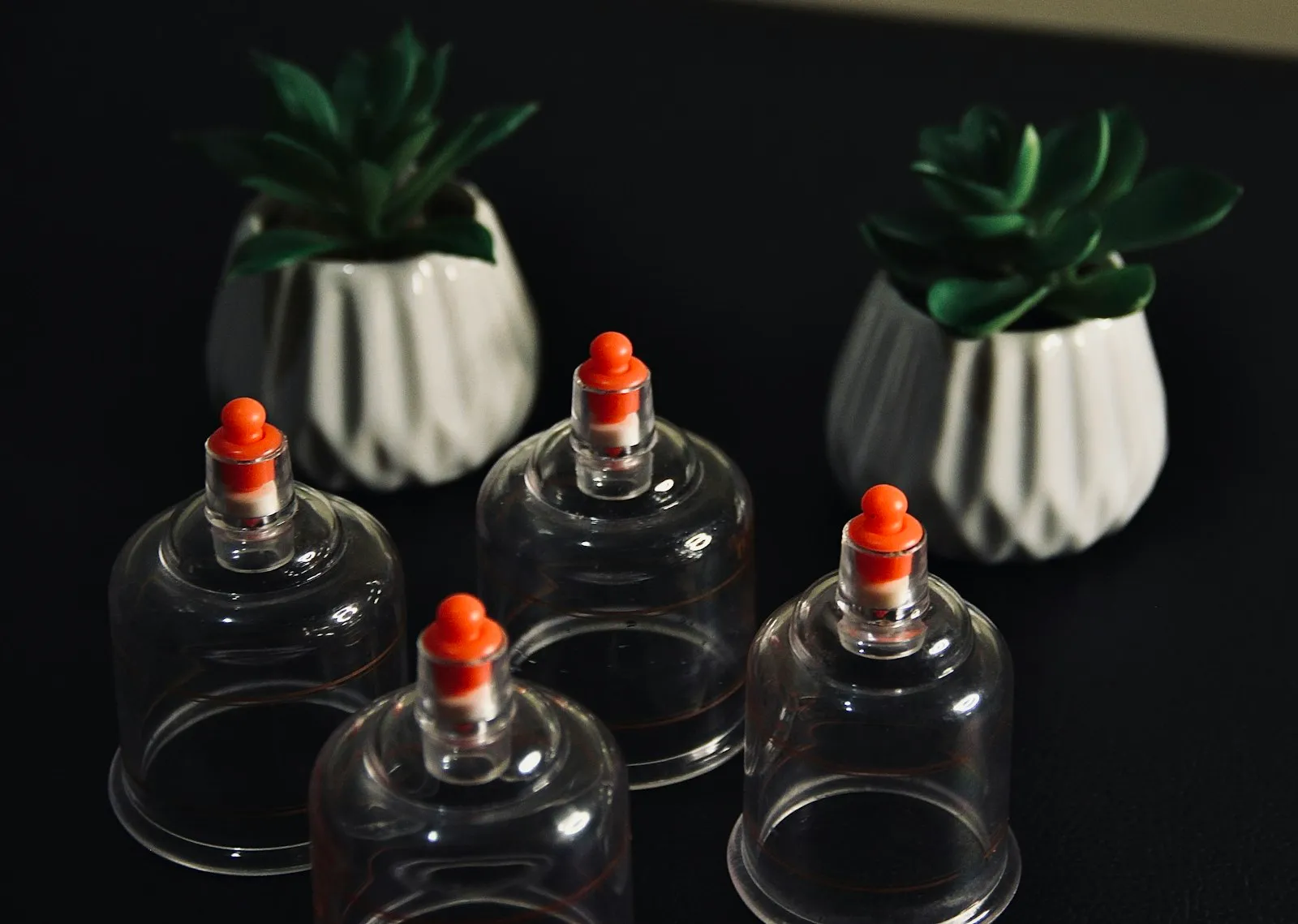 Clear cupping cups on a dark table