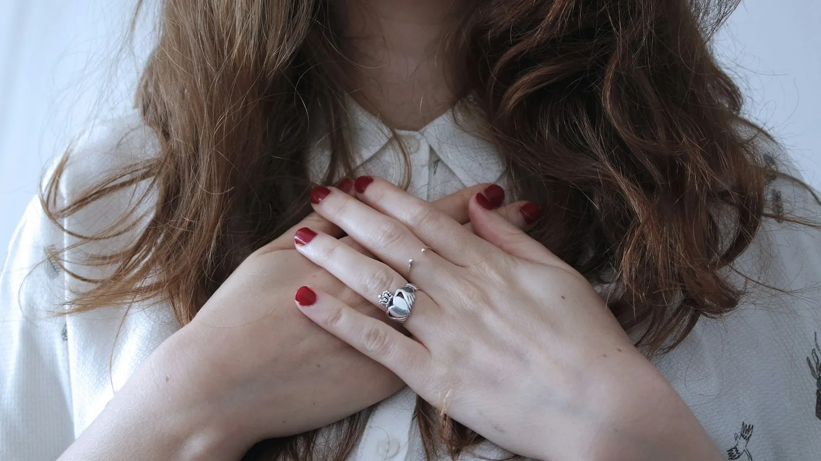 Hands resting calmly over the heart
