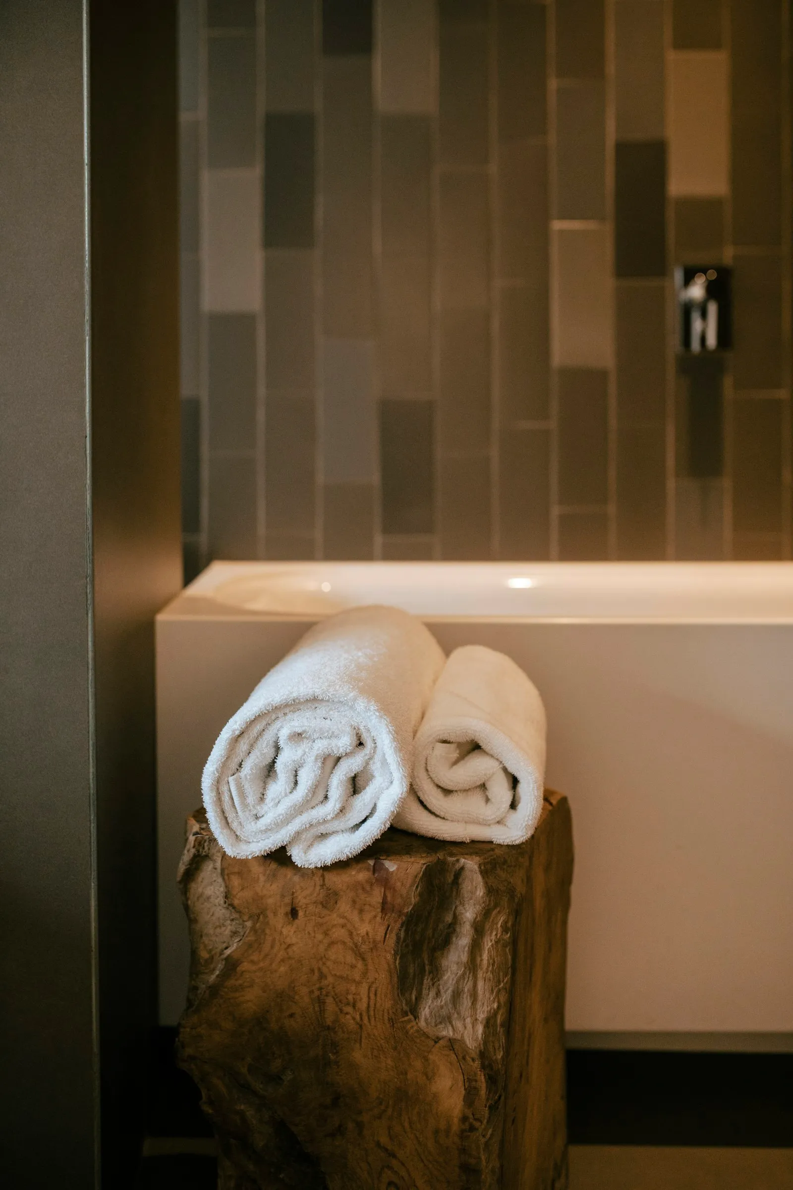 Rolled white towels ready in a calm spa space